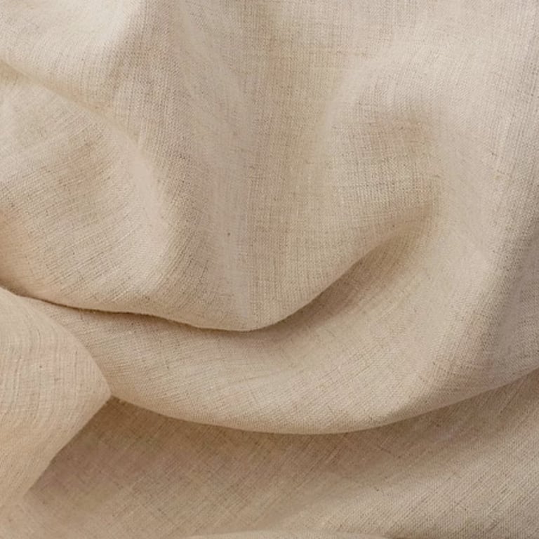 Close-up of beige linen fabric with soft folds and natural texture