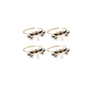 Set of four gold and black enamel bow-shaped napkin rings on white background