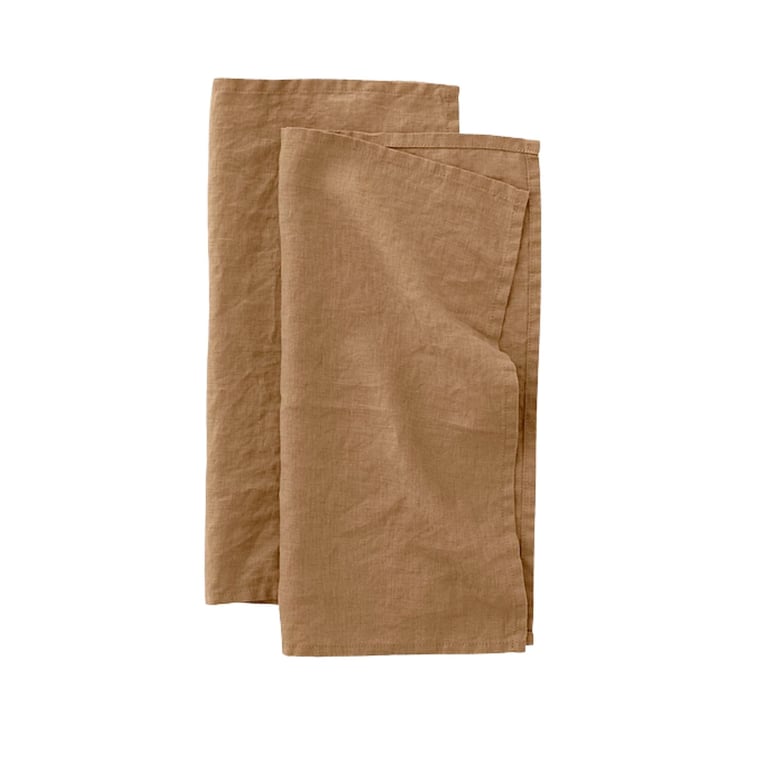 Two folded brown kraft paper napkins or dinner napkins stacked together