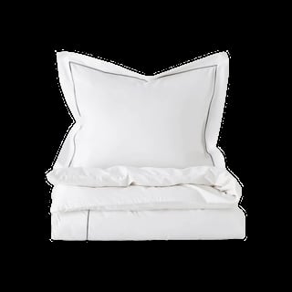 White bedding set with pillows and duvet cover neatly folded and stacked against black background