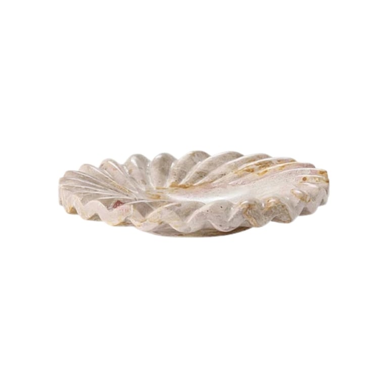 White and tan decorative shell bowl or dish with ridged texture on white background