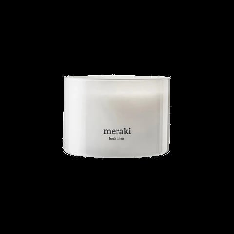 White cylindrical Meraki Fresh Linen scented candle on black background