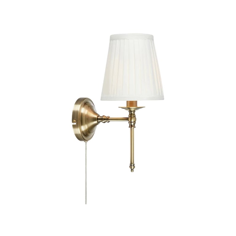 Brass wall sconce with cream pleated shade and pull chain switch