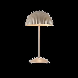Modern table lamp with dome-shaped ribbed shade and cylindrical metal base on black background