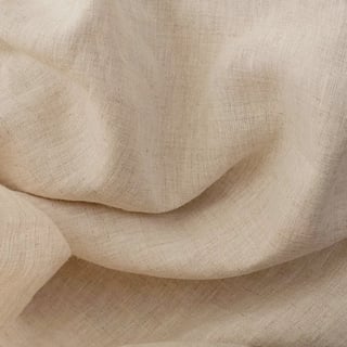 Crumpled beige linen fabric with soft folds and shadows